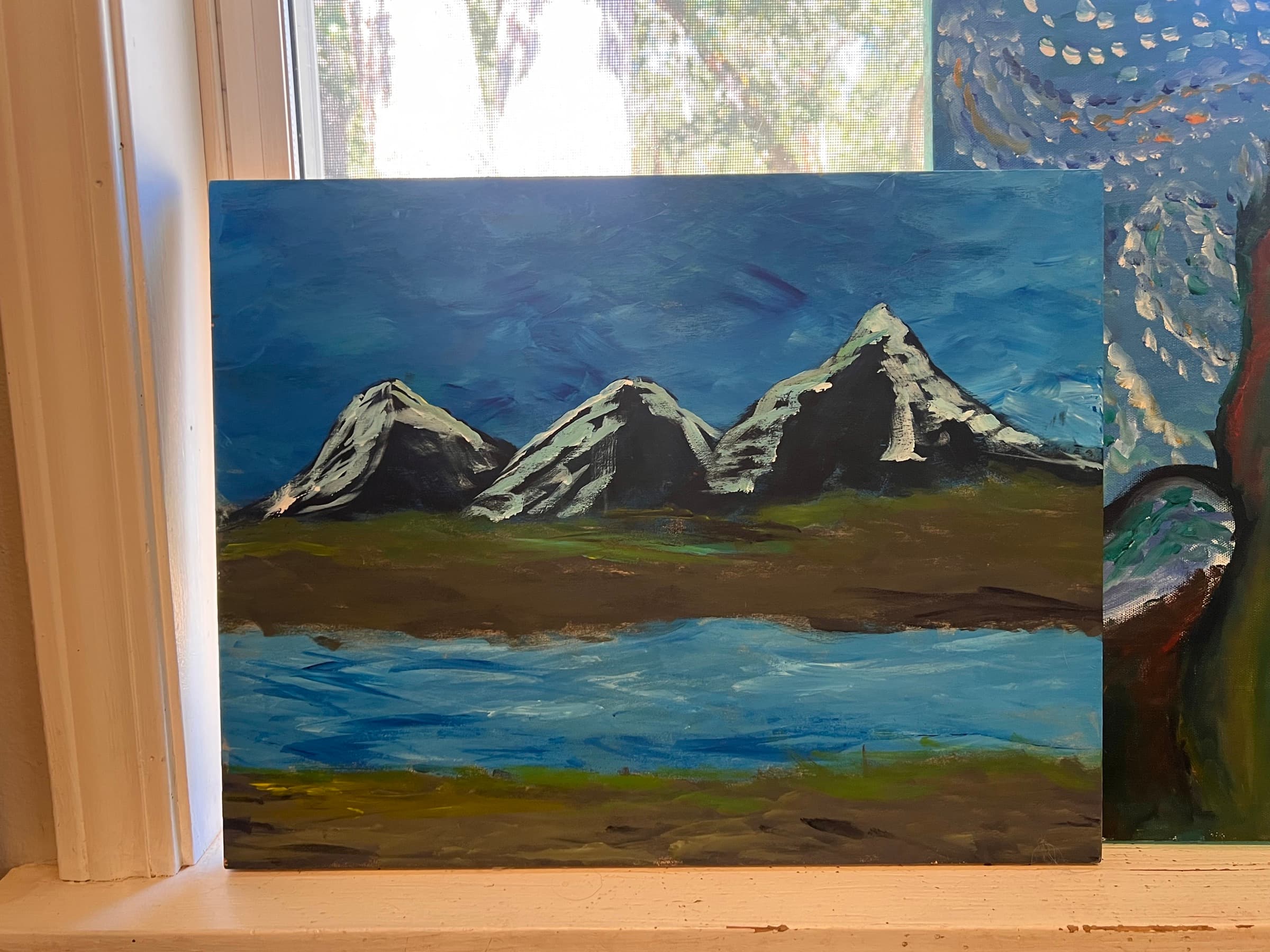 A painting of three snow-capped mountain peaks reflected in a lake under a deep blue sky